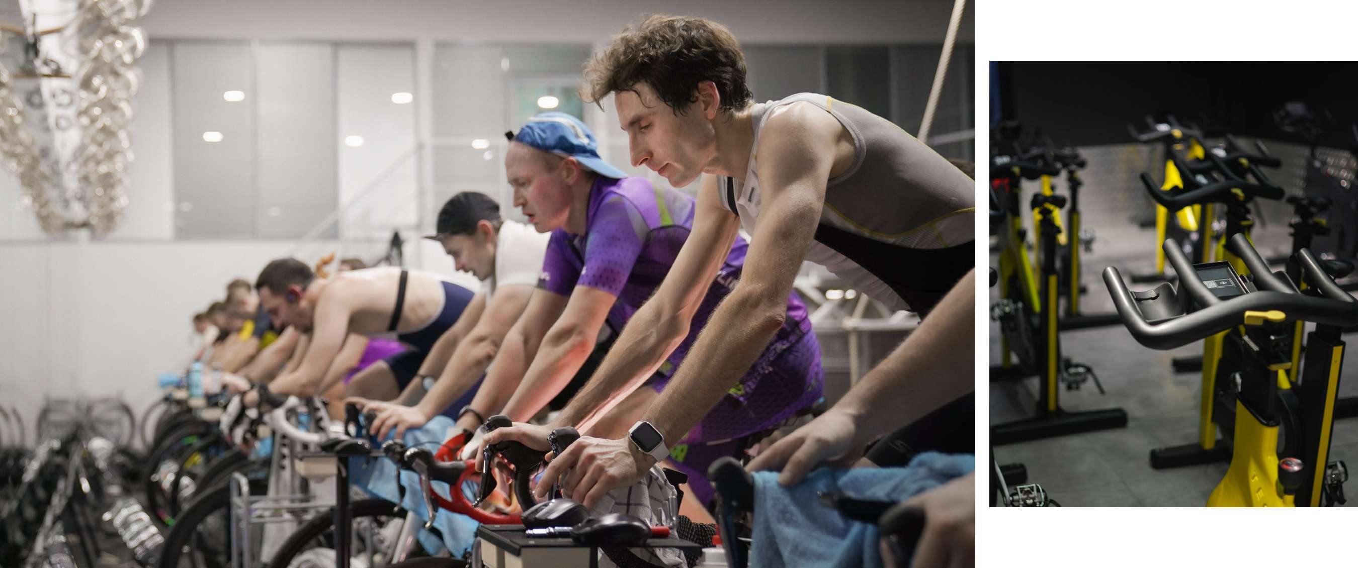 Plusieurs cyclistes s’entraînent côte à côte sur des vélos dans une salle de sport intérieure.